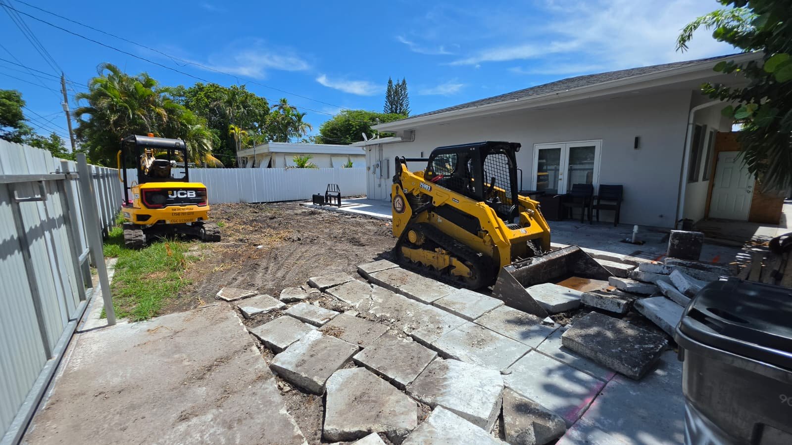 2Bro Construction skid-steer clearing a jobsite in Miami, FL